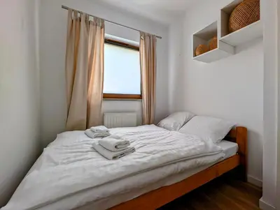 a bed with towels on it in a bedroom at Dworska 1B by Homeprime in Kraków
