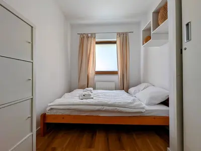 a small bedroom with a bed and a window at Dworska 1B by Homeprime in Kraków