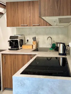 a kitchen with wooden cabinets and a table at Szarów 414 in Szarów