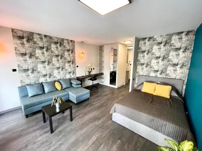 a bedroom with a bed and a couch and a table at Studio Karo in Kraków