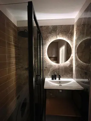 a bathroom with a sink and a mirror at Studio Karo in Kraków