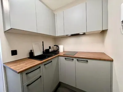 a kitchen with white cabinets and a counter top at Studio Karo in Kraków