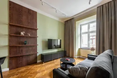 a living room with a couch and a tv at P19 Apartments in Kraków