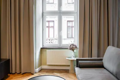 a living room with a couch and a window at P19 Apartments in Kraków