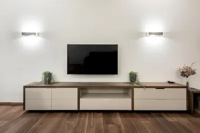 a living room with a tv on a white wall at P19 Apartments in Kraków