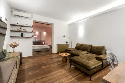a living room with a couch and a bed at P19 Apartments in Kraków