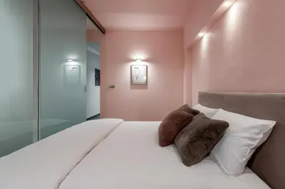 a bedroom with a white bed with two pillows at P19 Apartments in Kraków
