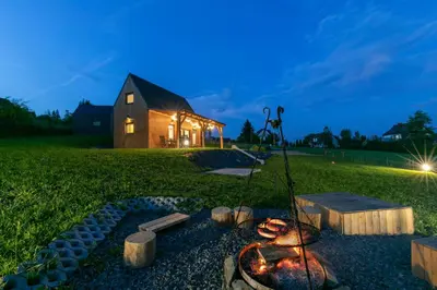 a fire pit in front of a barn at night at Casa Dobra in Dobra