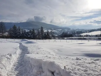 a snow covered field with a fence in the background at Casa Dobra in Dobra
