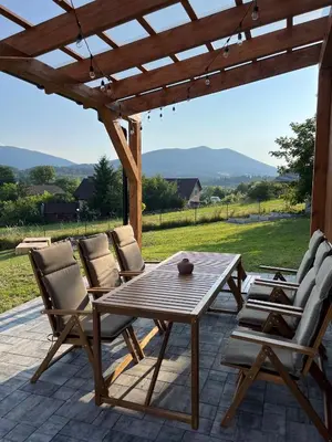 a wooden table and chairs on a patio at Casa Dobra in Dobra