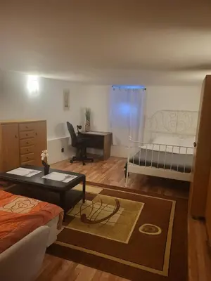 a bedroom with two beds and a desk and a table at Grzegorzecka Room 3 in Kraków
