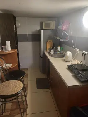 a small kitchen with a sink and a microwave at Grzegorzecka Room 3 in Kraków