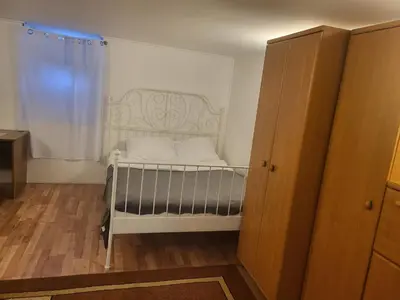 a small bed in a room with a window at Grzegorzecka Room 3 in Kraków