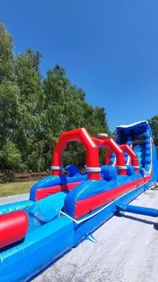 a blue and red water slide in a park at Sosnowy Domek Parter Zator Energylandia Graboszyce in Graboszyce