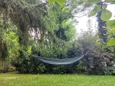a hammock hanging from a tree in a garden at Staruszka Chata in Sidzina