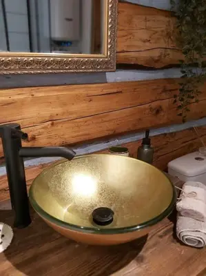 a sink in a bathroom with a mirror at Staruszka Chata in Sidzina