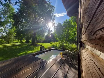 a deck with a plunge pool on a house at Staruszka Chata in Sidzina