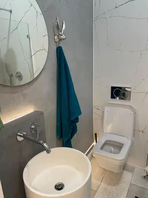 a bathroom with a sink and a toilet and a mirror at Dodo Acomodo 6 in Kraków