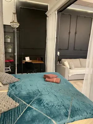 a bedroom with a bed with two towels on it at Dodo Acomodo 6 in Kraków