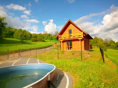 a small house with a pool in front of it at Słoneczna Chata dom Kasina Wielka in Kasina Wielka