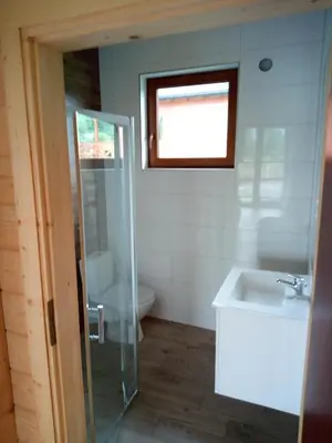 a bathroom with a sink and a toilet and a window at Słoneczna Chata dom Kasina Wielka in Kasina Wielka