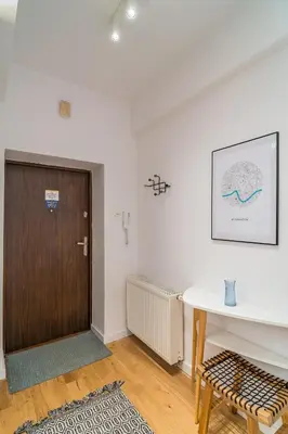 a room with a wooden door and a table at Kraków Wawel Apartment - Top Location, Workspace - by Rentujemy in Kraków