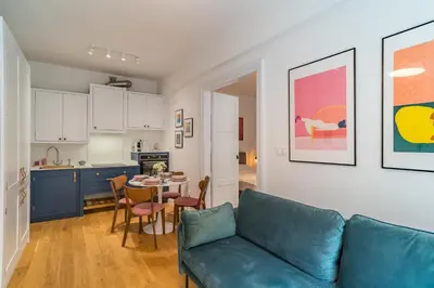 a living room with a couch and a table and a kitchen at Kraków Wawel Apartment - Top Location, Workspace - by Rentujemy in Kraków