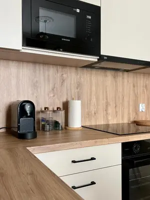 a kitchen with a microwave above a counter at Sebastiana Street Luxury Apartment in Kraków