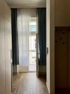 a hallway with a door with birds on the wall at Sebastiana Street Luxury Apartment in Kraków