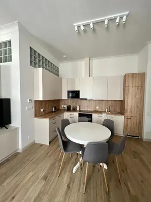 a kitchen with a table and chairs in a room at Sebastiana Street Luxury Apartment in Kraków