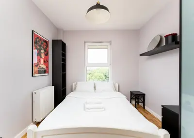a bedroom with a white bed and a window at Krowodrza 2-Bedroom Apartment by BookingHost in Kraków