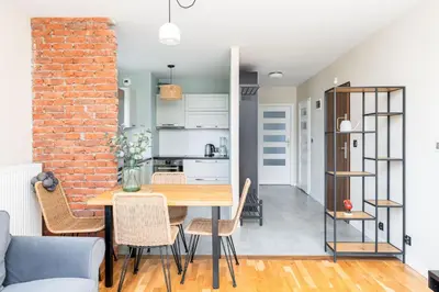 a kitchen and dining room with a table and chairs at Krowodrza 2-Bedroom Apartment by BookingHost in Kraków