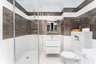 a bathroom with a shower and a toilet and a sink at Krowodrza 2-Bedroom Apartment by BookingHost in Kraków