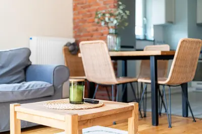 a living room with a coffee table with a glass on it at Krowodrza 2-Bedroom Apartment by BookingHost in Kraków