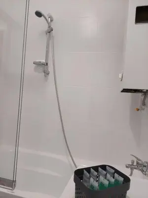 a bathroom with a shower and a basket of soap at Apartament Aleja 29 Listopada in Kraków