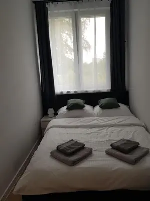 a bedroom with two beds with towels on them at Apartament Aleja 29 Listopada in Kraków