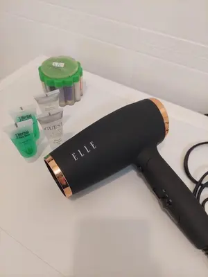 a black hair dryer sitting on top of a counter at Apartament Aleja 29 Listopada in Kraków