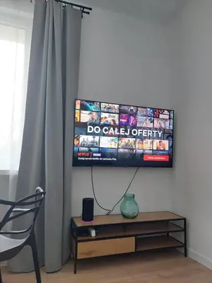 a flat screen tv hanging on a wall at Apartament Aleja 29 Listopada in Kraków