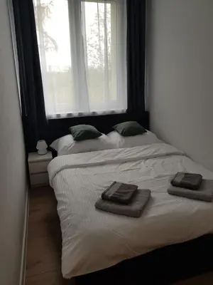 a bedroom with two beds with towels on them at Apartament Aleja 29 Listopada in Kraków