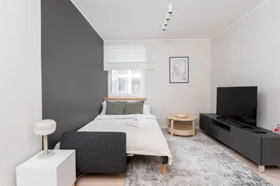 a bedroom with a bed and a flat screen tv at Old Town Modern Apartment by BookingHost in Kraków