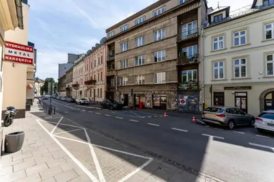 a city street with buildings and cars parked on the street at Old Town Modern Apartment by BookingHost in Kraków