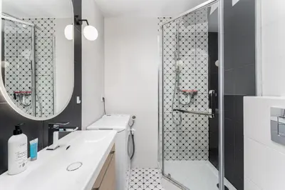 a bathroom with a sink and a shower at Old Town Modern Apartment by BookingHost in Kraków