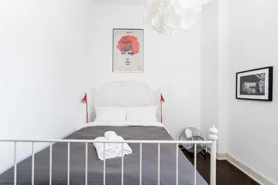 a small bedroom with a bed and a crib at Old Town Spacious Apartment by BookingHost in Kraków