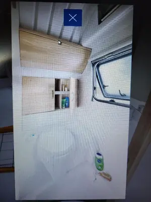 a small white room with a window and a door at Anser Collis in Wadowice
