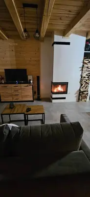 a living room with a couch and a fireplace at Domek Pod Skarpą in Wieprzec
