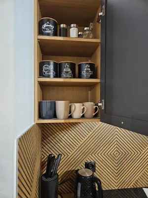 a cupboard with a bunch of coffee cups on it at Domek Pod Skarpą in Wieprzec