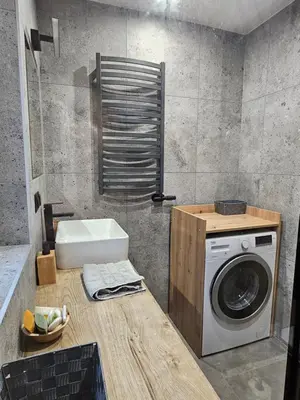 a bathroom with a washing machine and a sink at Domek Pod Skarpą in Wieprzec