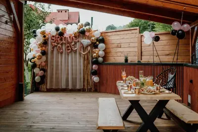 a table on a patio with a bunch of balloons at Domek Pod Skarpą in Wieprzec