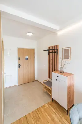 a room with a door and a table and a chair at Kraków Old Town - Bus&Tram Stops Nearby, Balcony - by Rentujemy in Kraków