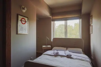 a bedroom with a bed with towels on it at SAW! KRAKÓW Apartments - Studencka in Kraków